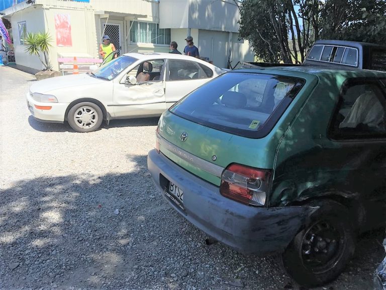 The driver's crashed car in front with the two damaged cars behind