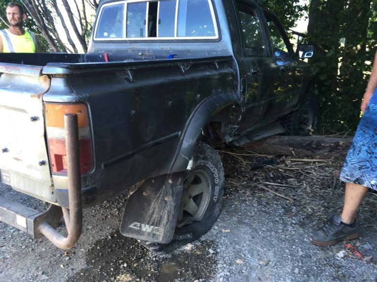 Truck with blown tyre off the edge of the car park