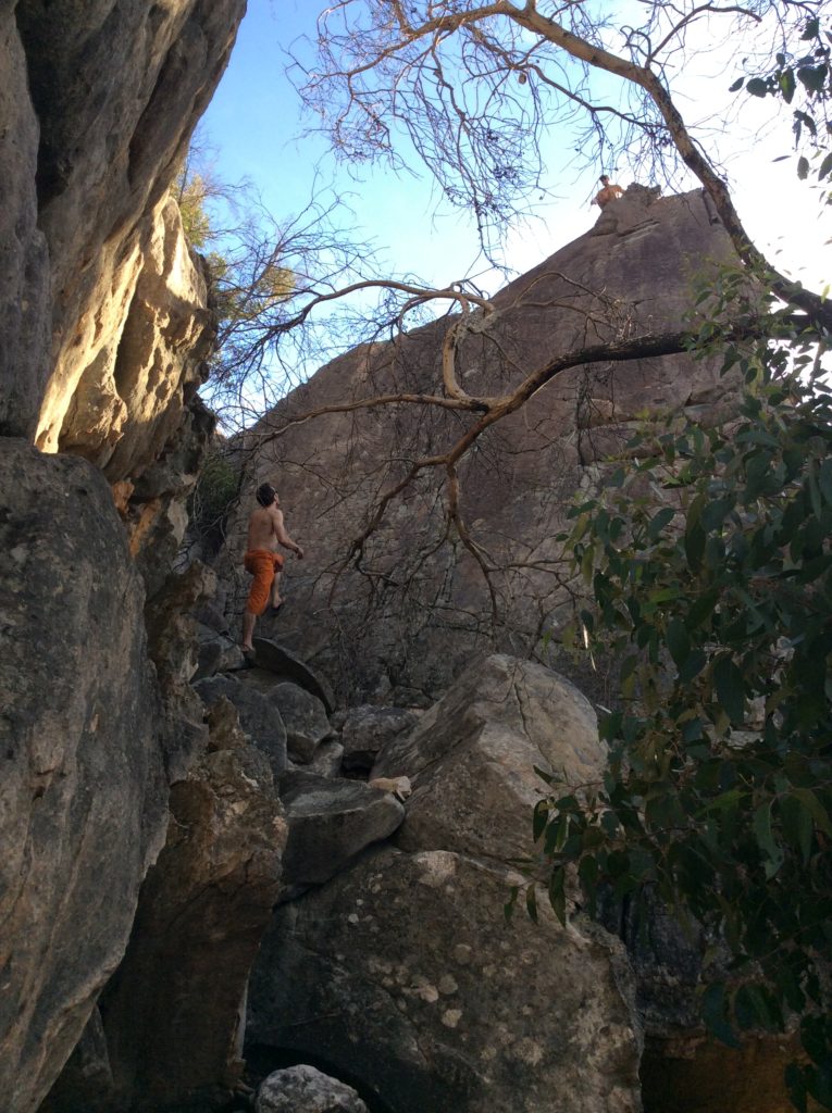 High rock climb with Vincent looking up from the bottom at Ben at the top