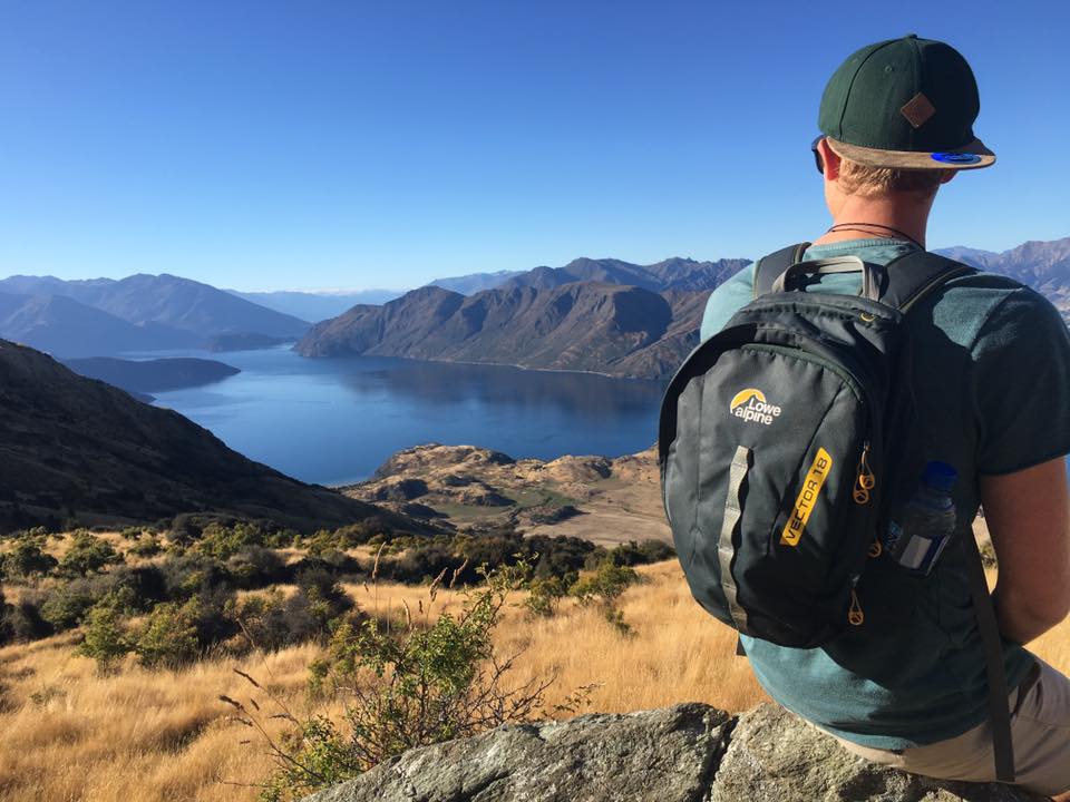 Giles Short close up of backpack facing towards view of lake and mountains