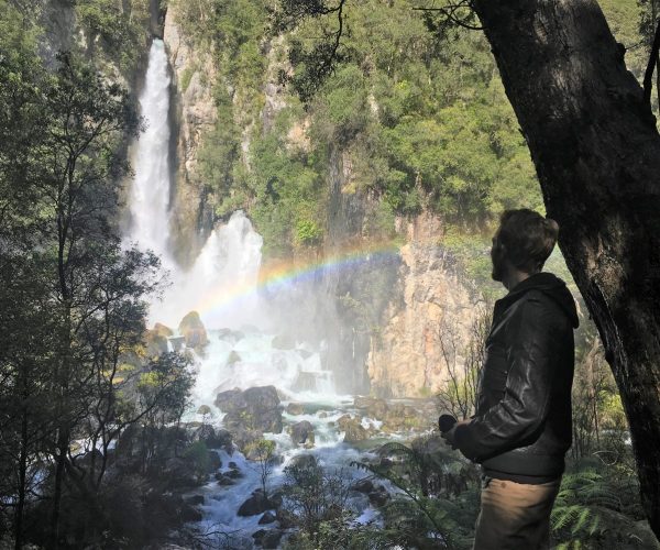 Giles Short looking at impressive waterfall with rainbow across it